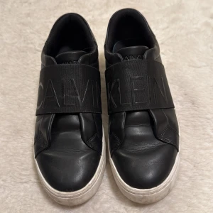 Svarta sneakers från Calvin Klein - Ursnygga Calvin Klein sneakers som går att ha till alla looks! Sparsamt använd med endast smuts på sula som går att tvätta av. Frakt inkluderat i priset!