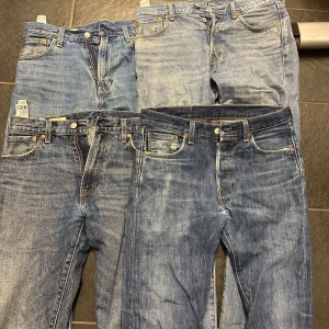 Levis 501 jeans i olika blå nyanser - Fyra par klassiska Levis 501 jeans i olika tvättar och blå nyanser. Alla har raka ben, fem fickor. Bara använda begränsat och sitter normalt i storlekarna. 