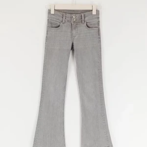 Grå bootcut jeans med dubbla knappar - Storlek 152 från Gina Tricot. 