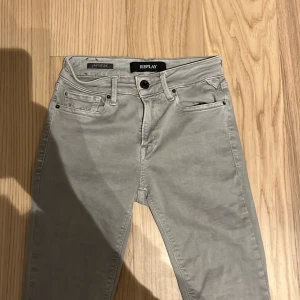 Grå Replay Anbass hyperflex - Snygga grå jeans från Replay i modellen Hyperflex. De har en klassisk femficksdesign med knapp och dragkedja framtill. Jeansen har en stilren look med diskreta sömmar på bakfickorna. Köpte från nån och det sa att det var 28w