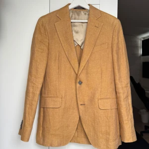 Beige kavaj från Oscar Jacobson - Snygg kavaj från Oscar Jacobson i beige med klassisk passform. Perfekt för dig som gillar stilrena och tidlösa plagg med en modern touch. Nypris 4999kr säljer ju för 1100kr och pris kan diskuteras vid snabb affär🤝🏽