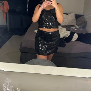 Svart paljettkjol och top. - Setet är köpt ifrån Australien, jätte fin och aldrig använd.