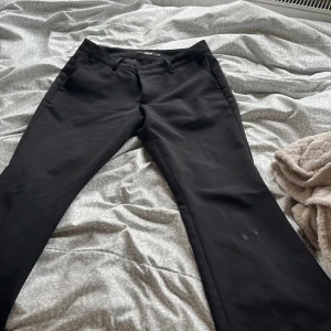 Svarta kostymbyxor från BikBok - Säljer ett par svarta kostymbyxor från BikBok med klassisk rak passform och fickor bak. Perfekta för en stilren look och passar till många olika outfits. Andvänd några ggr men säljer pga att den inte passar mig.