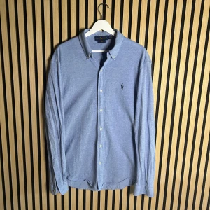 Ralph Lauren skjorta - Ljusblå Ralph Lauren skjorta. Skjortan är mjuk och lite tjockare än normalt. Featherweight mesh. Hör gärna av dig vid minsta fundering😊 Och besök gärna min profil för liknande😊