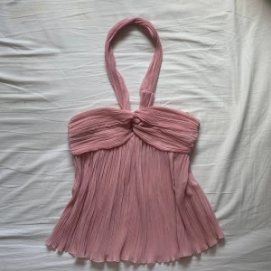 Rosa halterneck topp från Zara - Säljer den trendiga ljusrosa halterneck toppen från Zara 🫶Toppen har en luftig och flowy passform, perfekt för varma dagar. Supersnygg till både jeans och kjol!