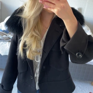 Meotine Jacka  - Jättefin kappa från meotine i modellen Charlie. Två knappar har låsnat på fickorna (en på varje ficka) vilket gör att det ser symmetriskt ut och inget man lägger märke till. En knapp längst ner har även låsnat och det finns en fläck inuti jackan som är väldigt svår att se och helt osynlig i vissa ljus. Utöver det är jackan i väldigt bra skick. Nypris 3000 kr