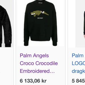 Svart sweatshirt Palm Angels krokodil - Svart sweatshirt från Palm Angels med broderad krokodil på bröstet och vit logga under. Tröjan har rund halsringning och långa ärmar, perfekt för dig som vill sticka ut med en cool detalj.