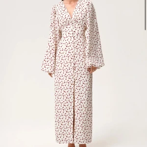 Vit långklänning med körsbärsmönster - Supersöt långklänning i vit med röda körsbär, från Adoore använt 1 gång! Så bra skick! Köparen står för frakten🫶🏽storlek 36