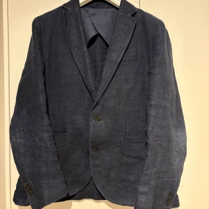 Blå linne kavaj från Massimo Dutti - Snygg blå kavaj från Massimo Dutti i italienskt tyg. Kavajen har två knappar framtill, klassiska slag och fickor på sidorna. Perfekt för dig som vill ha en stilren och modern look. Fortfarande otroligt snygg och hade själv velat ha men har tyvärr växt ur den. Köpt förra sommaren!🤩