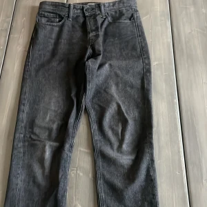 Svarta loose fit jeans från Jack & Jones - Säljer ett par svarta jeans från Jack & Jones i loose fit-modell. Det är storlek 30/34 så de passar rätt så många. Hör av er vid intresse eller köp direkt så fraktar jag samma dag!