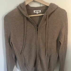 Beige hoodie från Soft Goat - Säljer en supermjuk beige hoodie från Soft Goat i storlek XS men passar även S. Fårn den gammla damkollektion. Den har dragkedja framtill och en klassisk huva med dragsko. Perfekt för kyliga dagar när du vill ha något bekvämt och stilrent. 🐐✨