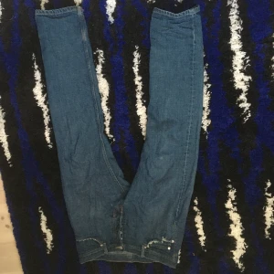 Blå jeans från Weekday - Säljer ett par klassiska blå jeans från Weekday med raka ben och normal passform. Jeansen har fem fickor och stängs med dragkedja och knapp. Perfekta till vardags och enkla att matcha med olika stilar.