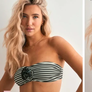 Svartvit randig bandeau bikiniöverdel - Snygg bandeau bikiniöverdel med svartvita ränder och en dekorativ blomdetalj framtill. Perfekt för stranddagar och soliga semesterdagar. Utan axelband för en stilren look.