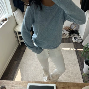 Ljusblå stickad tröja - Mysig ljusblå stickad tröja med rund halsringning och långa ärmar. Tröjan har en enkel och stilren design som passar perfekt till jeans eller kjol. Skön och avslappnad passform, perfekt för kyligare dagar. Har blivit lite knottrig