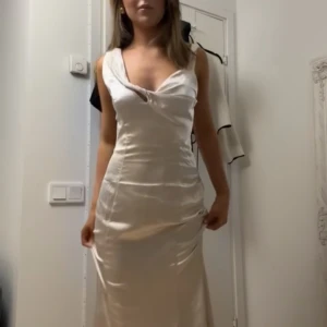 Balklänning  - Helt ny (prislapp kvar), jättefin off-white/beige långklänning i satin, asymmetrisk upptill och superfin passform - perfekt balklänning!! Var tyvärr för stor för mig