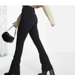 Bootcut jeans - Svarta stretchiga bootcut jeans med hög midja, knappt använda inga tecken på användning passar storlek S - W28L32, hög midja Midja 34 cm Innerlår 81 cm Hela byxans längd ca 105 cm