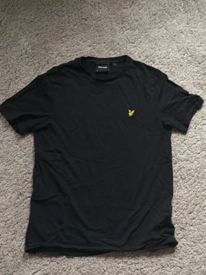Lyle & Scott Svart T-Shirt - Lyle & Scott Svart t-shirt helt ny. För dig som vill se mer stilig ut på vardagen. STORLEK XS.