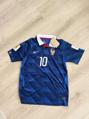 Blå Frankrike fotbollströja Mbappé - Säljer en blå fotbollströja med vita och röda detaljer, nummer 10 och Mbappé på ryggen. Bra quality och kommer med sin påse 