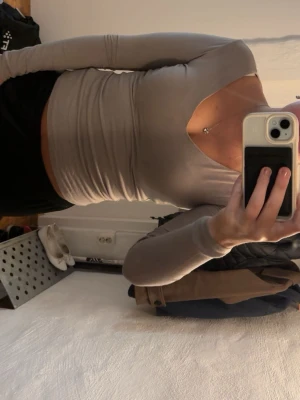 Beige långärmad topp från Amisu - Säljer en beige långärmad topp från Amisu med v-ringad hals och tight passform. Toppen är enkel och stilren, perfekt att matcha med både jeans och kjol. Materialet känns mjukt och följsamt mot kroppen.