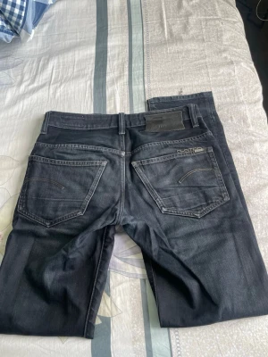 Mörkblå raka jeans - Snygga mörkblå jeans med raka ben och klassisk femficksdesign. Jeansen har diskreta sömmar och en svart patch bak i midjan. Passar perfekt till en avslappnad stil och är tillverkade i ett mjukt denimtyg.