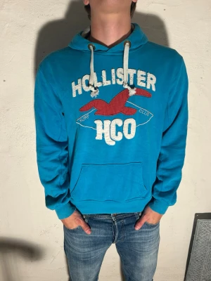 Hollister ~ Vintage - Snygg blå hoodie från Hollister storlek S. Går att pruta vid snabbaffär. Hör av er vid minsta fundering. Modell är 185cm.