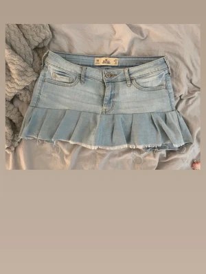 Ljusblå volangkjol i jeans från Hollister - .Superduper fin kjol i perfekta ljusblåfärgen och perfekta volangen, sytt den själv därav pris! Jeansen är orginalt från hollister så riktigt fina! Storlek w27 i midjan vilken motsvarar S!❤️ kom med egna prisförslag!🙌🥰
