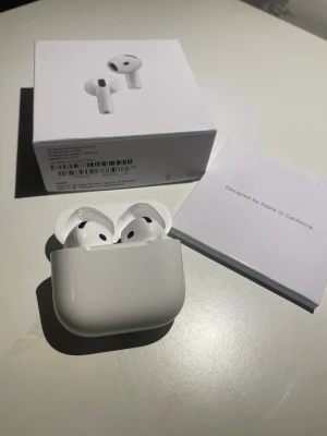 Aipods - Snygga vita Aipods med laddningsetui. Trådlösa in-ear-hörlurar i stilren design, perfekt för musik, samtal och träning. Kommer med originalförpackning och manual. Smidig och kompakt form som passar i fickan.