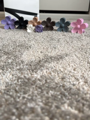  hårklämmor blommor i olika färger - Jag säljer 6 stora blomhårklämmor och 2 små. Ur och pen. Nypris 49kr styck.