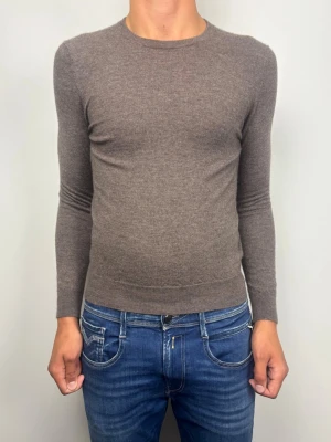 Suitsupply Pure 100% Cashmere Tröja Brun Storlek S - Exklusiv brun crewneck-tröja i 100% cashmere från Suitsupply.  Mjuk, finstickad och i mycket fint skick  B Grade) med ribbade muddar. Figurnära och skön passform.  Tveka inte att höra av dig vid frågor eller funderingar.   Mått [platt] :  A: 61 cm B: 62 cm C: 40 cm  OBS: Sitter för litet och för tight på killen i bilden! Skickas snabbt!