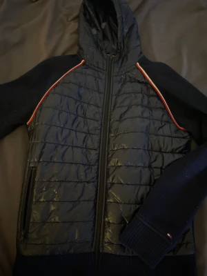 Hybrid jacka av Tommy Hilfiger - En snygg hybrid jacka med både stickat och gilet material. Jackan är av storlek S.  