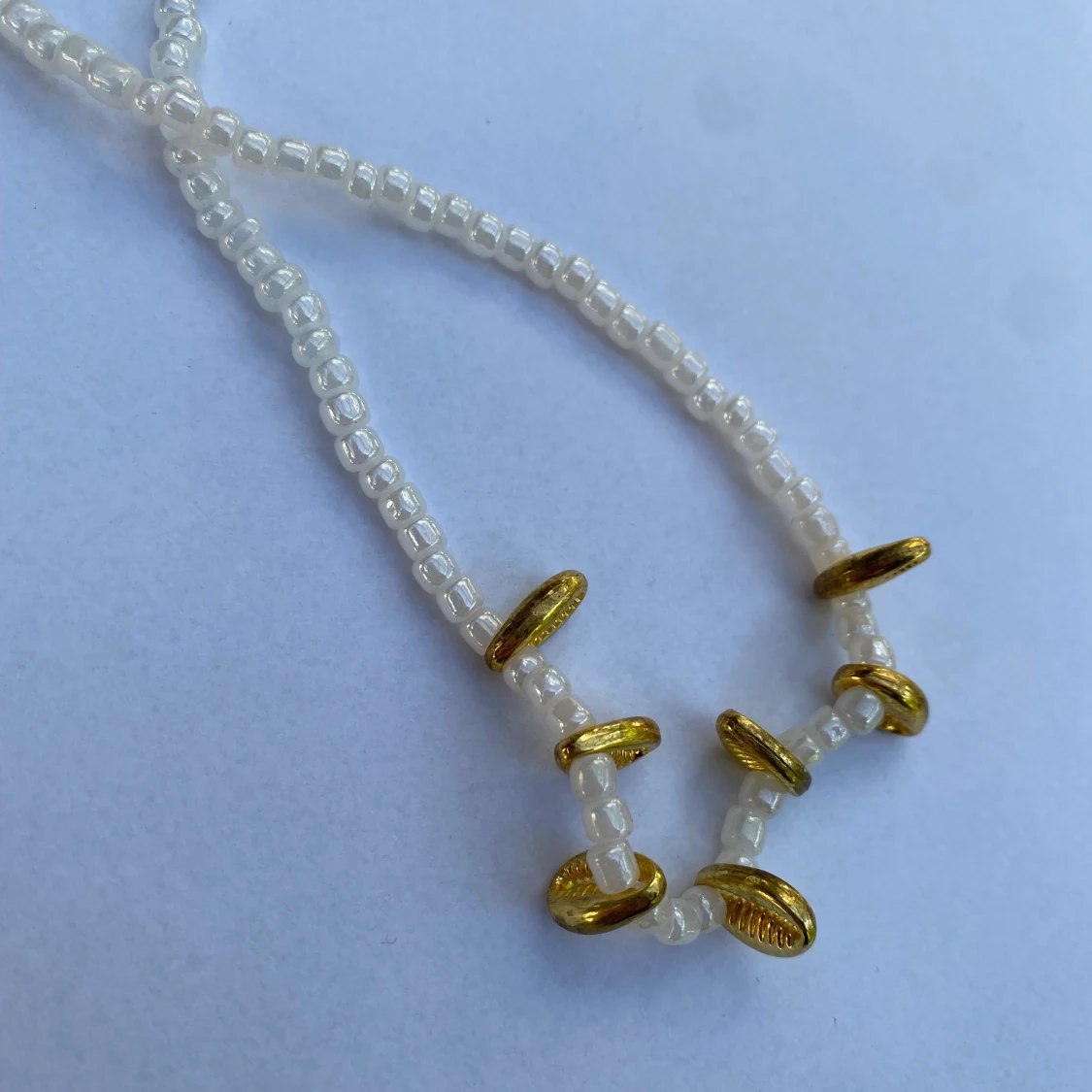 Pärlhalsband med guld snäckor