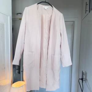 Ljusrosa kappa - Ljusrosa kappa från HM, strl 36. Sparsamt använd! Fin men kommer aldrig till användning 