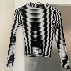 Långärmad svartvit tröja - Långärmad tröja från Monki. Snygg med liten polo och svartvita ränder! 