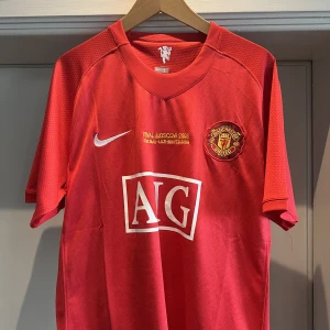 Manchester United Matchtröja 08/09 - Manchester United Matchtröja från deras säsong 08/09 när de vann Champions League mot Chelsea. United legendaren Rio Ferdinand på ryggen.