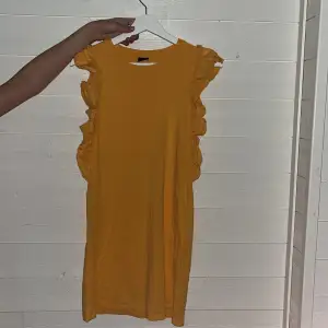 en fin gul klänning med volang 
