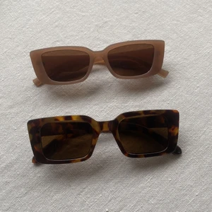 Solglasögon - Två par solglasögon. Aldrig använda.