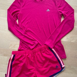 Rosa short och träningstopp från Adidas. Stl 34/36  - Fina nya shorts från Adidas i fin rosa färg. Fin tröja till som endast är använd 2-3 gånger. Stl 36 på shorts och 36 på tröja. Passar 34/36  Pris 140:- + porto   Djur och rökfritt hem  Köparen står för frakten 