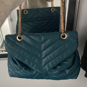 Väska, liknar Yves saint laurent  - Jättefin mörkgrön väska, går att ha både som axelremsväska och crossbody. Liknar Yves saint laurent. Har lite sminkfläckar inuti men inget som stör