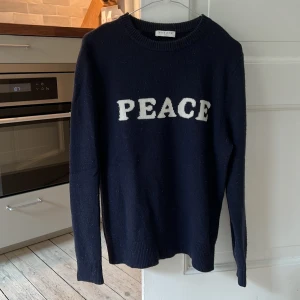 Sandro stickad cashmere/ylle blend - Sandro storlek S/M stickad blend i cashmere och ylle, superskön och snygg! färgen är mörkblå med vita bokstäver. passar både tjejer och killar, regular fit