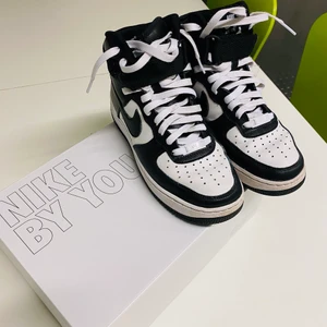 Airforce High Nike By You - Airforce 1 High Nike By You  Storlek EU 38,5 Skorna är i fint skick (se bilden). Använda väldigt lite pga att dom snabbt blev för små. Färg: Svart och vit Inkluderar originalboxen   Nypris: 1599kr