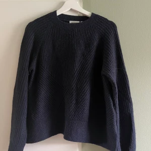 Stickad tröja från Weekday - Stickad rymligt tröja från Weekday i strl XS. 40 % akryl, 29 % polyamid, 22 % ull, 7 % mohair och 2 % elastan. I använt skick och är lite smånopprig, vilket förmodligen går att ta bort om man orkar. 