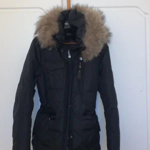 Hollies vinterjacka dam - Hollies dam vinter jacka i storlek 42, men går att göra större och mindre med hjälp av banden inuti. Är i väldigt bra skick utan defekter. Pris kan diskuteras.