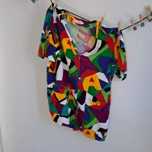 Very quirky, fun and colourful shirt with crazy pattern on. Fits like a size S/M.