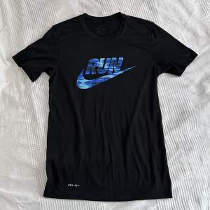 Skön tröja att träna i från Nike med coolt tryck i blått. T-shirt modell, går att använda till vardags. Bra skick!
