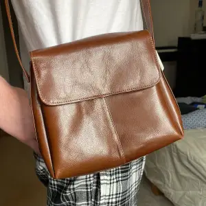 En chokladbrun mellanstor väska med mycket utrymme och många fickor. Köpt på myrorna, jag har nästan inte använt den alls.