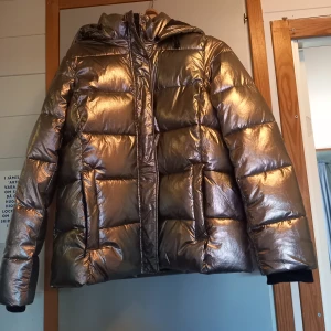 Jacka - Oanvänd. Mycket snyggt moderiktigt plagg. Metallic.