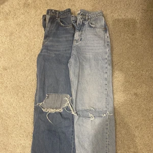 Håliga jeans - 2 par jeans strl 32 med stora hål på knäna. 1 par från Ginatricot och 1 par från H&M.
