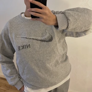 Nike rhinestone tröja - Grå nike tröja med rhinestones. Inga rhinestones saknas och tröjan har inga defekter. Mer som en S. Frakt tillkommer:)