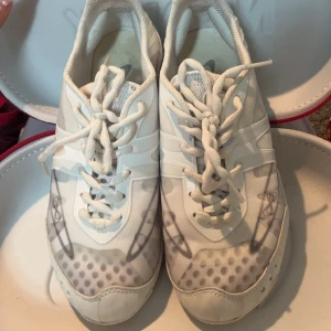 Vita cheer skor från Nfinity - Säljer ett par vita cheer skor från Nfinity, modell Vengeance. Skorna har snörning och är designade för cheerleading med en lätt och flexibel konstruktion. Perfekta för träning och tävling. Nypris 1480. I nyskick. Storlek 37.