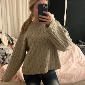 Beige stickad tröja - Mysig beige stickad tröja med kabelstickat mönster. Tröjan har långa ärmar och en avslappnad passform, perfekt för kyliga dagar. Passsr allt ifrån S-L. Skriv om ni har några frågor!💞